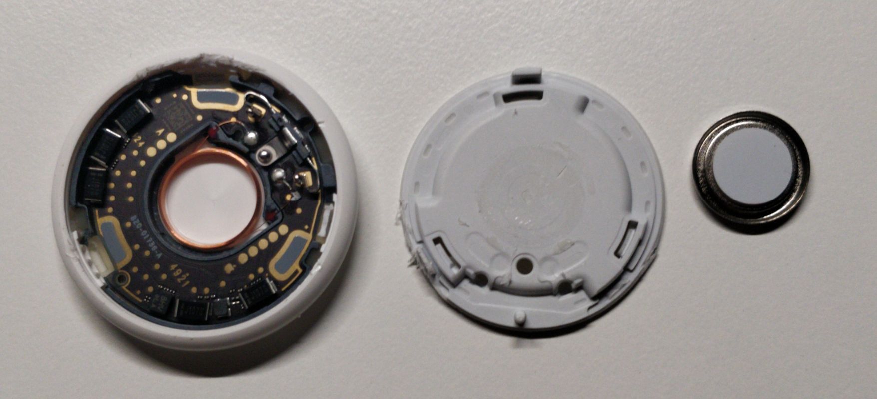 From left to right: AirTag board, midplate and speaker separated